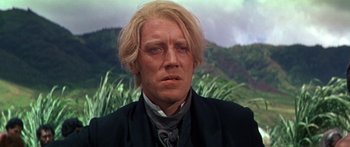 Movie still from “Hawaii” (1966), directed by George Roy Hill – A person wearing a suit and tie; Close Up shot, Low angle