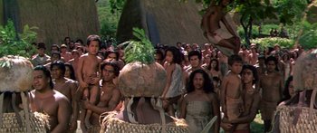 Movie still from “Hawaii” (1966), directed by George Roy Hill – A group of people standing around a large pot; Wide shot, High angle