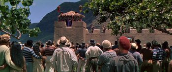 Movie still from “Hawaii” (1966), directed by George Roy Hill – A crowd of people standing around a building; Extreme Wide shot, High angle