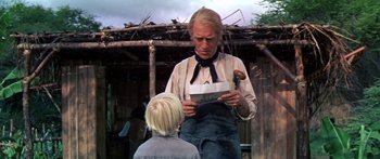 Movie still from “Hawaii” (1966), directed by George Roy Hill – An older woman and a young boy in front of a building; Medium shot, Low angle