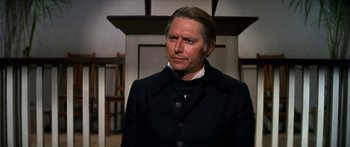 Movie still from “Hawaii” (1966), directed by George Roy Hill – A person wearing a suit and tie; Close Up shot, Over the shoulder angle