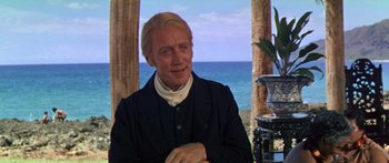 Movie still from “Hawaii” (1966), directed by George Roy Hill – A person sitting in front of the ocean; Medium shot, Over the shoulder angle