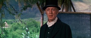 Movie still from “Hawaii” (1966), directed by George Roy Hill – A man wearing a top hat and a black jacket; Close Up shot, Low angle