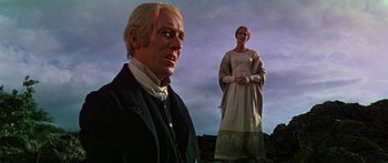 Movie still from “Hawaii” (1966), directed by George Roy Hill – A man and a woman standing on top of a hill; Medium shot, Low angle