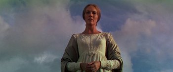 Movie still from “Hawaii” (1966), directed by George Roy Hill – A woman standing in front of a cloudy blue sky; Medium shot, Low angle