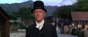 Movie still from “Hawaii” (1966), directed by George Roy Hill – A man wearing a top hat and a black suit; Medium shot, Low angle