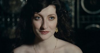 Movie still from “House of Tolerance” (2011), directed by Bertrand Bonello – A person wearing a necklace; Close Up shot, High angle