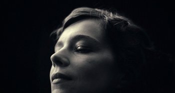 Movie still from “House of Tolerance” (2011), directed by Bertrand Bonello – A woman's face in black and white; Extreme Close Up shot, Low angle