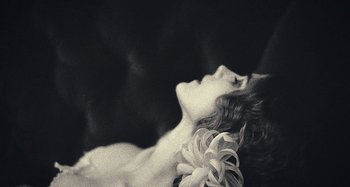 Movie still from “House of Tolerance” (2011), directed by Bertrand Bonello – A black and white photo of a woman laying on her stomach; Extreme Close Up shot, Low angle