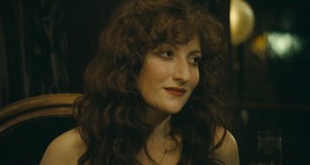 Movie still from “House of Tolerance” (2011), directed by Bertrand Bonello – A person with long curly hair; Close Up shot, High angle