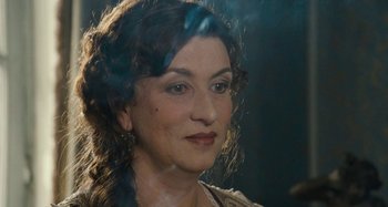 Movie still from “House of Tolerance” (2011), directed by Bertrand Bonello – A woman's face in the dark; Close Up shot, Over the shoulder angle