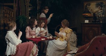 Movie still from “House of Tolerance” (2011), directed by Bertrand Bonello – A group of women sitting around a table; Wide shot, High angle