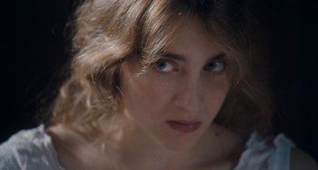 Movie still from “House of Tolerance” (2011), directed by Bertrand Bonello – A woman's face with blue eyes; Close Up shot, High angle