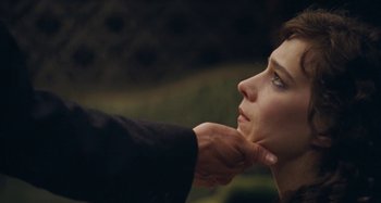 Movie still from “House of Tolerance” (2011), directed by Bertrand Bonello – A person touching the neck of another person; Close Up shot, Over the shoulder angle