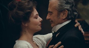 Movie still from “House of Tolerance” (2011), directed by Bertrand Bonello – An older man and a younger woman embracing each other; Close Up shot, Low angle