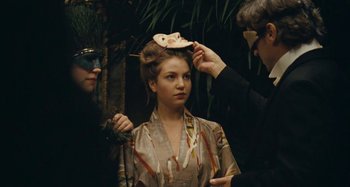 Movie still from “House of Tolerance” (2011), directed by Bertrand Bonello – A woman getting her hair done by two men; Close Up shot, Over the shoulder angle