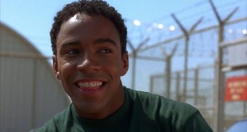 Movie still from “Jason's Lyric” (1994), directed by Doug McHenry – A person smiling for the camera; Close Up shot, Low angle