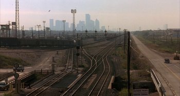 Movie still from “Jason's Lyric” (1994), directed by Doug McHenry – A view of a train track with a city in the background; Extreme Wide shot, High angle