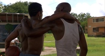 Movie still from “Jason's Lyric” (1994), directed by Doug McHenry – A couple of men standing next to each other; Medium shot, Low angle