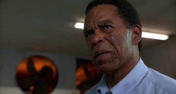 Movie still from “Jason's Lyric” (1994), directed by Doug McHenry – An older man is looking into the camera; Close Up shot, Low angle