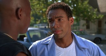 Movie still from “Jason's Lyric” (1994), directed by Doug McHenry – A man in a white shirt and blue jacket talking to another man in a white shirt and blue jacket; Close Up shot, Over the shoulder angle