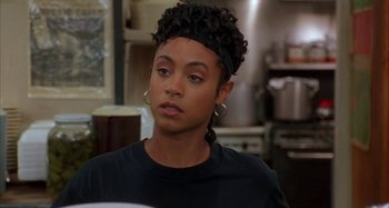 Movie still from “Jason's Lyric” (1994), directed by Doug McHenry – A woman with a black headband and a black shirt; Close Up shot, Over the shoulder angle