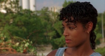 Movie still from “Jason's Lyric” (1994), directed by Doug McHenry – A person wearing a jean shirt; Close Up shot, Over the shoulder angle