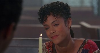 Movie still from “Jason's Lyric” (1994), directed by Doug McHenry – A woman sitting in front of a lit candle; Close Up shot, Over the shoulder angle
