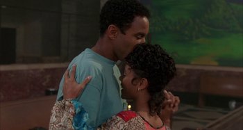 Movie still from “Jason's Lyric” (1994), directed by Doug McHenry – A man and a woman are kissing in a room; Medium shot, High angle