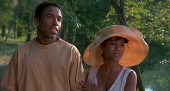 Movie still from “Jason's Lyric” (1994), directed by Doug McHenry – A man standing next to a woman wearing a hat; Close Up shot, Over the shoulder angle