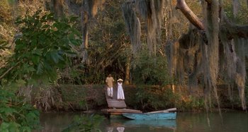 Movie still from “Jason's Lyric” (1994), directed by Doug McHenry – A man and a woman standing on a dock near a boat; Extreme Wide shot, High angle