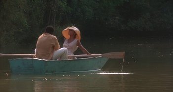 Movie still from “Jason's Lyric” (1994), directed by Doug McHenry – A man and a woman are in a boat on the water; Wide shot, High angle