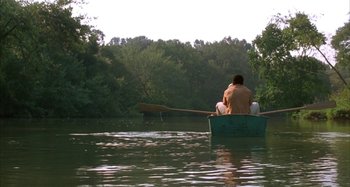 Movie still from “Jason's Lyric” (1994), directed by Doug McHenry – Two people are in a boat on a river; Extreme Wide shot, High angle