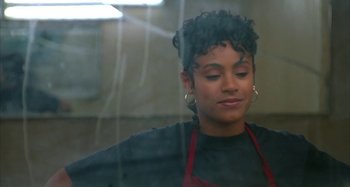 Movie still from “Jason's Lyric” (1994), directed by Doug McHenry – A woman in an apron looking out of a window; Close Up shot, Over the shoulder angle