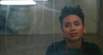 Movie still from “Jason's Lyric” (1994), directed by Doug McHenry – A woman sitting in front of a glass window; Close Up shot, Over the shoulder angle
