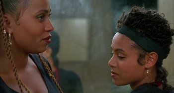 Movie still from “Jason's Lyric” (1994), directed by Doug McHenry – Two women talking to each other in front of a wall; Close Up shot, Over the shoulder angle