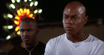 Movie still from “Jason's Lyric” (1994), directed by Doug McHenry – A couple of men standing next to each other; Close Up shot, Low angle