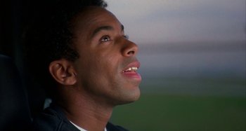 Movie still from “Jason's Lyric” (1994), directed by Doug McHenry – A person looking up at the sky; Close Up shot, Low angle