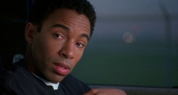 Movie still from “Jason's Lyric” (1994), directed by Doug McHenry – A person sitting in front of a window; Close Up shot, Over the shoulder angle