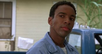 Movie still from “Jason's Lyric” (1994), directed by Doug McHenry – A person wearing a blue shirt; Close Up shot, Low angle
