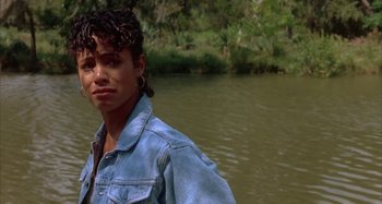 Movie still from “Jason's Lyric” (1994), directed by Doug McHenry – A woman standing in front of a body of water; Close Up shot, Over the shoulder angle