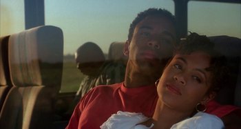 Movie still from “Jason's Lyric” (1994), directed by Doug McHenry – A man and a woman sitting next to each other in a vehicle; Close Up shot, Low angle