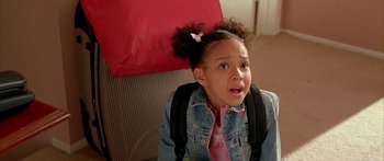 Movie still from “Johnson Family Vacation” (2004), directed by Christopher Erskin – A little girl wearing a jacket and a pink tie; Close Up shot, High angle