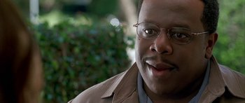 Movie still from “Johnson Family Vacation” (2004), directed by Christopher Erskin – A person wearing glasses and a jacket; Close Up shot, Low angle