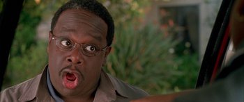 Movie still from “Johnson Family Vacation” (2004), directed by Christopher Erskin – A person wearing glasses and a brown shirt; Close Up shot, High angle