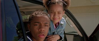 Movie still from “Johnson Family Vacation” (2004), directed by Christopher Erskin – A young boy and a young girl are posing for a picture; Close Up shot, Low angle