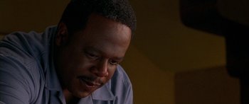 Movie still from “Johnson Family Vacation” (2004), directed by Christopher Erskin – A person sitting down looking down; Close Up shot, High angle