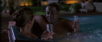 Movie still from “Johnson Family Vacation” (2004), directed by Christopher Erskin – A man and a woman are in a hot tub; Medium shot, High angle