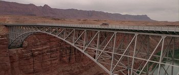 Movie still from “Johnson Family Vacation” (2004), directed by Christopher Erskin – A bridge that is over a river in the middle of the desert; Extreme Wide shot, High angle