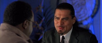 Movie still from “Johnson Family Vacation” (2004), directed by Christopher Erskin – A person wearing a suit and tie; Close Up shot, Over the shoulder angle